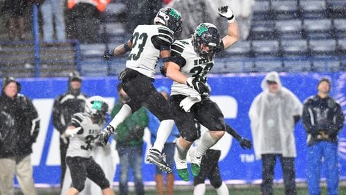 Harrison's Brandon Carter (23) and Marcus Bleazard (32) celebrate in the second half during the AAAAAA state championship game Friday, Dec. 13, 2019, at Georgia State Stadium in Atlanta. Harrison won 20-7 over Allatoona.