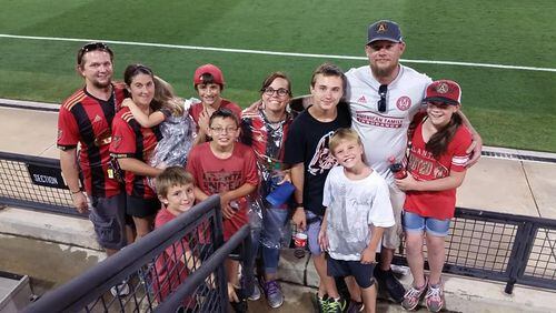 Atlanta United fan Josh Proctor with friends and family at an Atlanta United game.