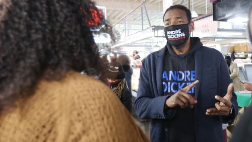 Andre Dickens speaks with a customer at the Sweet Auburn Curb Market while campaigning on Saturday, Nov. 20. (Miguel Martinez for The Atlanta Journal-Constitution)