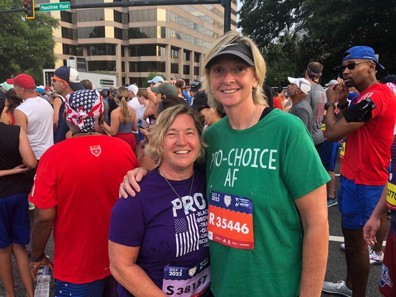Beth (right) and wife Metta Sweet promote abortion rights at the Atlanta Journal-Constitution Peachtree Road Race on Monday, July 4, 2022 in Atlanta.