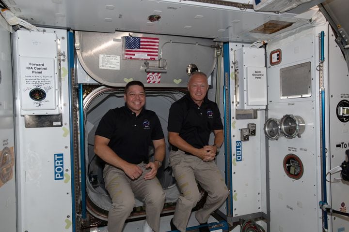 A photo provided by NASA shows the astronauts Bob Behnken, left, and Doug Hurley, having just entered the orbiting lab of the International Space Station shortly after arriving aboard the SpaceX Crew Dragon spacecraft, on May 31, 2020. Behnken and Hurley are getting ready to splash down after two months in orbit. (NASA via The New York Times) -- FOR EDITORIAL USE ONLY. --
