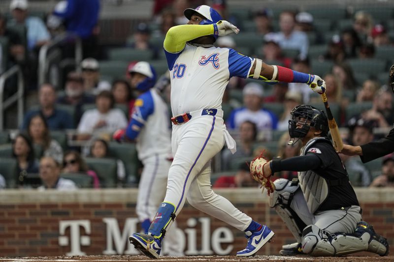 Atlanta Braves designated hitter Marcell Ozuna (20) hits a double against the Cleveland Guardians in the second inning of a baseball game, Saturday, April 27, 2024, in Atlanta. (AP Photo/Mike Stewart)