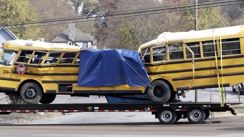 Mounted on a flatbed trailer, Woodmore Elementary School bus 366 is taken away from the crash site on Nov. 21. Six children died aboard the bus when it careened off the road and slammed into a tree and a telephone poll. (AP Photo/Mark Humphrey)