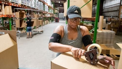 Pro-Built Logistics Warehouse associate Nicole Stewart  boxing e-commerce orders at the Ooltewah, Tenn., location on Sept. 7, 2022. (Photo by Mark Gilliland for The Atlanta Journal-Constitution)