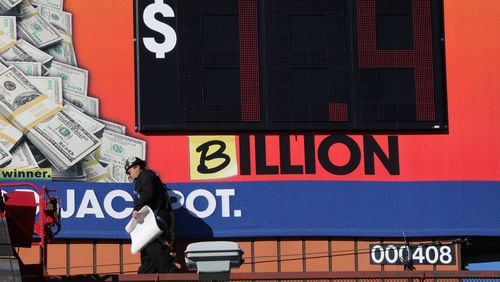 January 11, 2016, Atlanta: Tim Baldwin walks off after adding a "B" to a Georgia Lottery billboard near Turner Field on Monday afternoon January 11, 2016 to reflect the Powerball jackpot which has grown to $1.4 billion after nobody won Saturday night's drawing. Ben Gray / bgray@ajc.com