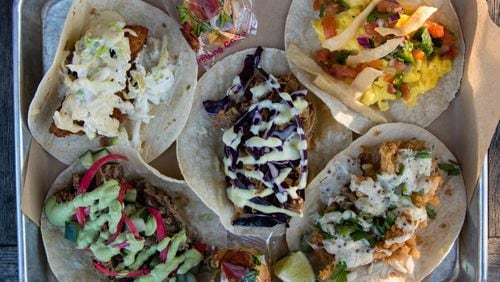 A tray of five tacos at Strange Taco Bar in Lawrenceville (clockwise from top left): fried fish, migas, fried clam, braised lamb and braised duck. CONTRIBUTED BY HENRI HOLLIS