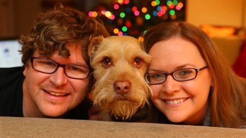 Health care reporter Misty Williams, her injured boyfriend Jason Massad, and their dog Wally pose for a portrait at home in Dunwoody. CURTIS COMPTON / CCOMPTON@AJC.COM