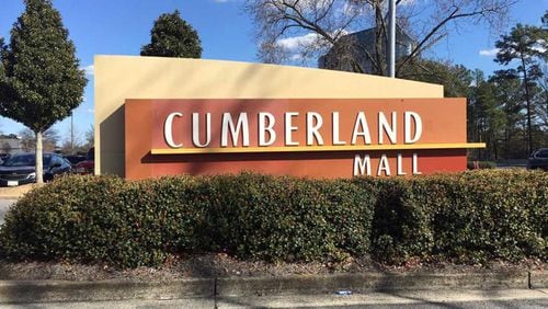 An arrest warrant was issued after police searched a cellphone found at the scene of a shootout between two cars near Cumberland Mall.