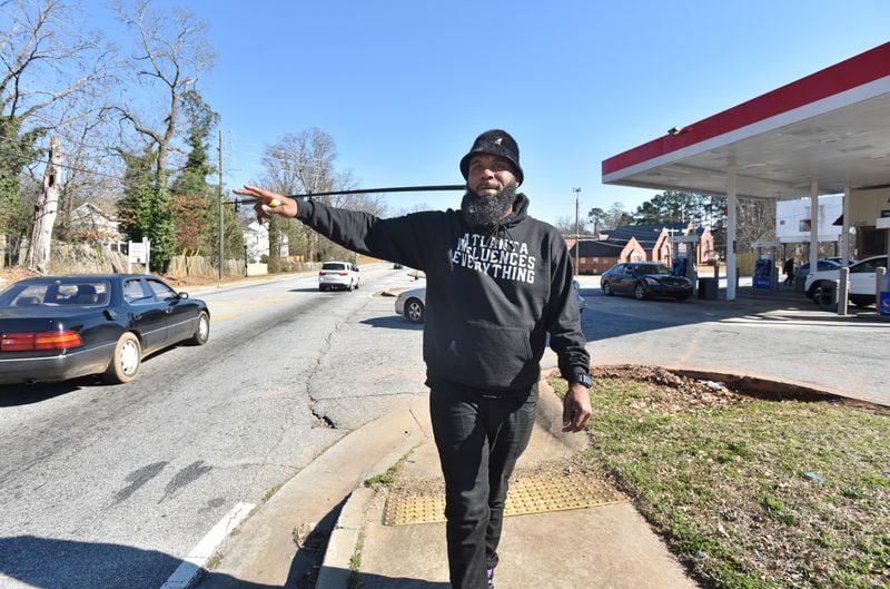 February 24, 2021 Atlanta - Brian Page waves as he is recognized by a neighbor outside the Exxon gas station in his southwest DeKalb neighborhood on Wednesday, February 24, 2021. Page launched a protest and boycott of the Exxon gas station in his Southwest DeKalb neighborhood, after a clerk told one customer he didn't "give a f--- about the black community" and the owner called him a "food stamp cockroach." They protested outside the store for 66 days -- and it worked. The owner agreed to sell. (Hyosub Shin / Hyosub.Shin@ajc.com)