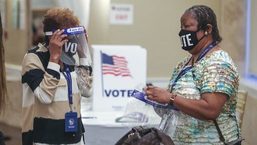 August 11, 2020 Atlanta: Poll workers Shirley Favors (left ) and Jocelyn Samuel (right) prepare to open the polls at Park Tavern in Atlanta on Tuesday, August 11, 2020 at Park Tavern located at 500 10th St NE in Atlanta. A heated race for Fulton County district attorney saw a light turnout at the polls on Tuesday, August 11, 2020. Incumbent Paul Howard faces his former chief deputy, Fani Willis, in a closely watched contest to become the countyÕs top prosecutor. Election officials said they learned lessons from the June 9 primary to avoid the kind of extreme lines that some voters encountered last time. Poll workers have been retrained. Technicians were on hand at every voting location in Cobb, DeKalb, Fulton and Gwinnett counties. Voting machines were delivered well in advance of election day. Still, some voters experienced problems and long waits at the polls. Nearly 377,000 Georgians already voted in advance of election day, most of them casting absentee ballots. About 60% of early votes were absentee; the rest were cast in person during three weeks of early voting. With so many voters using absentee ballots, election results might be slow to come in Tuesday night. Absentee ballots will be counted if theyÕre received by county election officials before 7 p.m., but each ballot has to be fed through a scanner to be counted, a process that can take days. Election officials say itÕs normal for absentee vote-counting to take some time. But that means close races might not be settled on election night. The winners of TuesdayÕs runoffs will advance to the general election in November, when turnout is expected to break records and exceed 5 million voters. JOHN SPINK/JSPINK@AJC.COM

