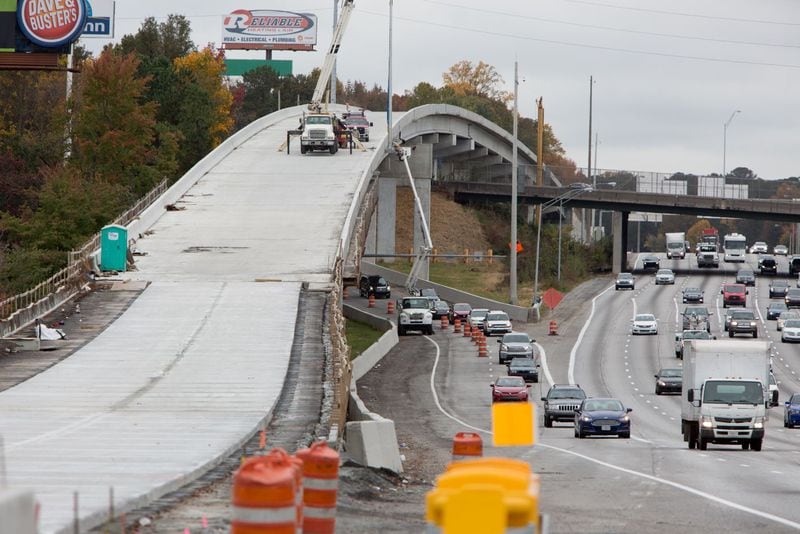 The Northwest Corridor Express Lanes, seen here under construction last year, rise and fall beside the regular lanes on I-75 in Cobb County. A Conyers man has nicknamed the toll lanes the “Tollercoaster,” and hopes the name will stick. PHIL SKINNER/AJC