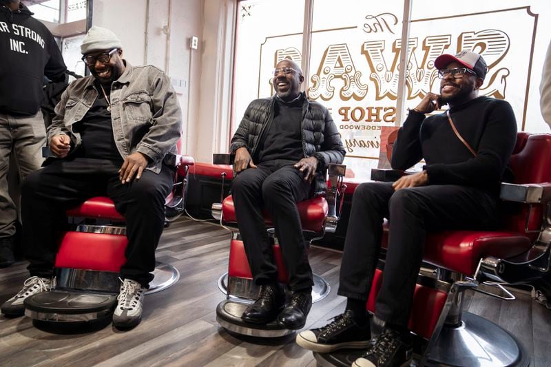 U.S. Sen. Raphael Warnock (D-Ga.), center, sits down for a talk with Killer Mike (Mike Render), left, and D-Nice at the SWAG Shop barbershop in Atlanta, on Monday, Dec. 5, 2022. Render, an Atlanta-based rapper and entertainer, recently won a Southeast Emmy for his WABE interview program “Love & Respect with Killer Mike.” (Nicole Craine/The New York Times)