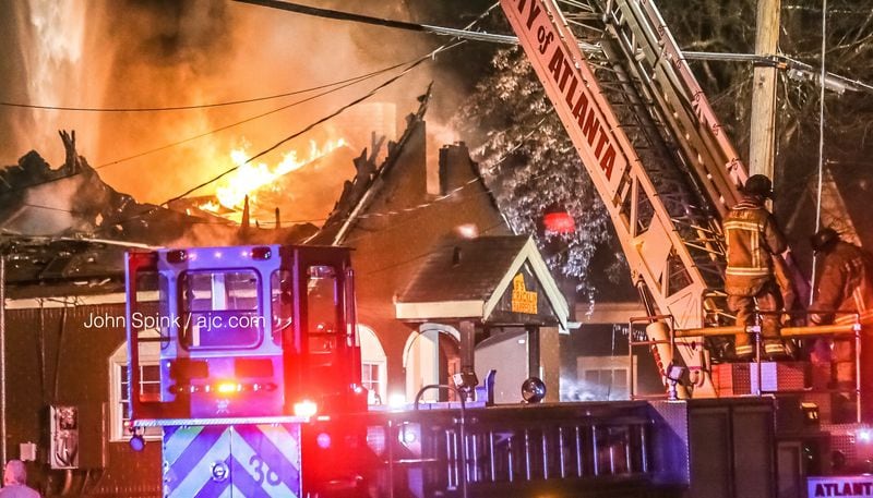 Fire crews worked to put out flames shooting from the roof of B's Cracklin' Barbecue in the Riverside neighborhood of northwest Atlanta Wednesday morning.