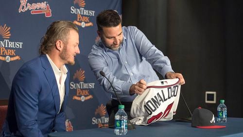 Atlanta Braves general manager Alex Anthopoulos (right) shows Josh Donaldson his new jersey during a press conference Tuesday, Nov. 27, 2018, in Atlanta.