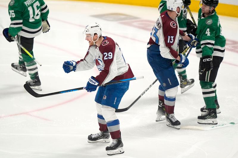 Colorado Avalanche center Nathan MacKinnon (29) celebrates in front of right wing Valeri Nichushkin (13) and Dallas Stars defenseman Miro Heiskanen (4) after scoring a goal in the third period in Game 2 of an NHL hockey Stanley Cup second-round playoff series in Dallas, Tuesday, May 7, 2024. (AP Photo/LM Otero)