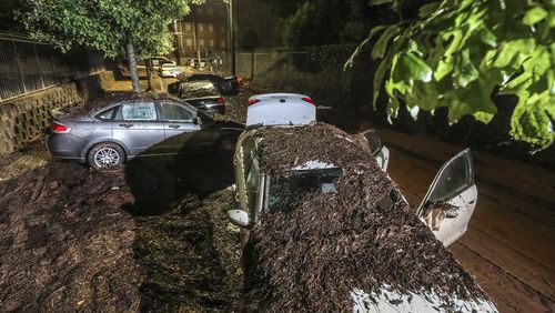Along Parsons Street near Lawshe Street through Clark Atlanta University, so much mud was left behind that it looked like a dirt road as flooded cars remained after the water receded Friday morning, Sept. 15, 2023. (John Spink/The Atlanta Journal-Constitution/TNS)