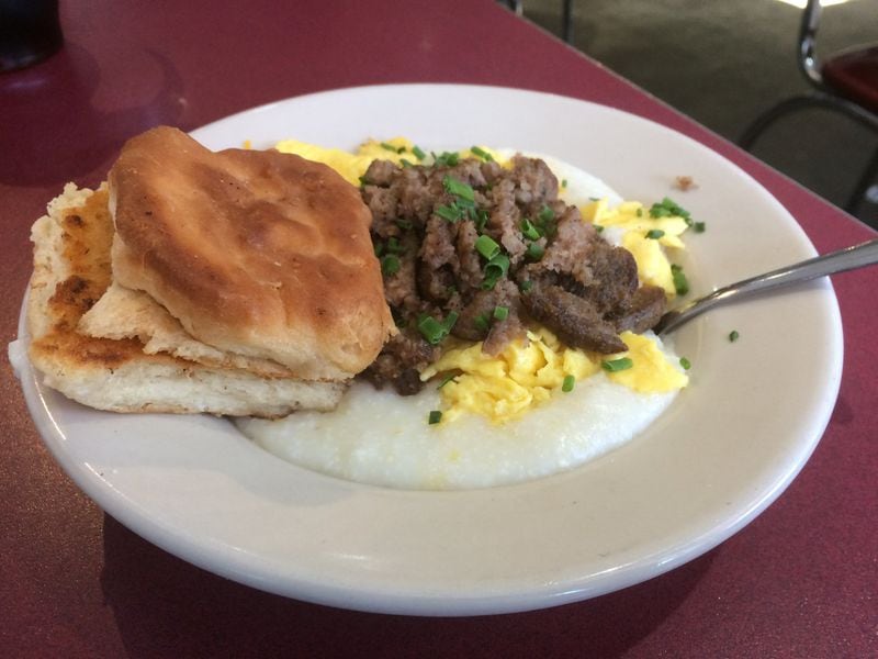 Atlanta Breakfast Club’s breakfast bowl comes with grits, scrambled eggs, sharp cheddar, and choice of meat. It’s shown here with pork sausage and a biscuit. CONTRIBUTED BY WENDELL BROCK