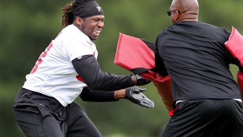 May 30, 2018 Flowery Branch: Atlanta Falcons defensive end Takkarist McKinley works with new assistant defensive line coach Travis Jones on a rushing drill during organized team activity on Wednesday, May 30, 2018, in Flowery Branch.  Curtis Compton/ccompton@ajc.com