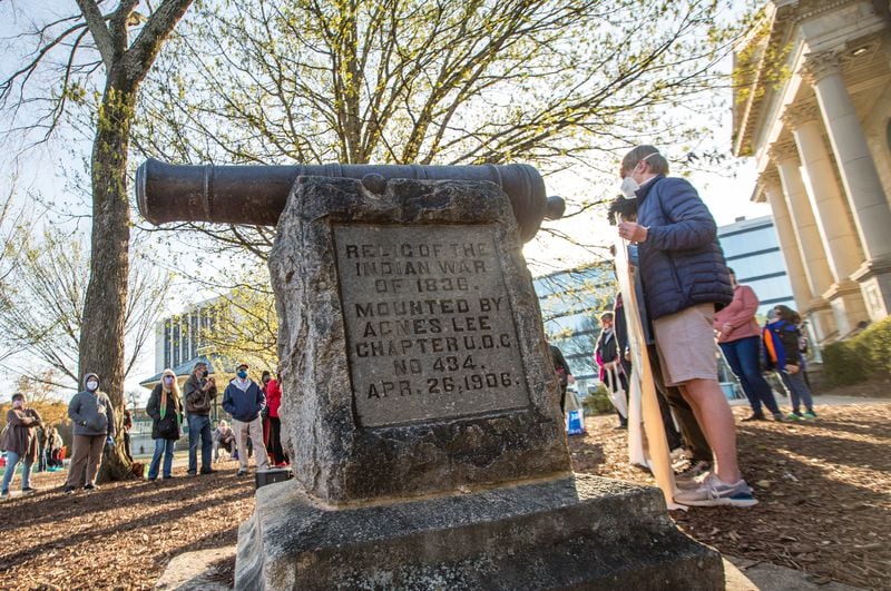 A rally in support of removal of a cannon in Decatur Square gathers in March 2021. The war relic serves as a monument in DeKalb County marking the end of the 1836 "Indian War." (Jenni Girtman for The Atlanta Journal-Constitution)
