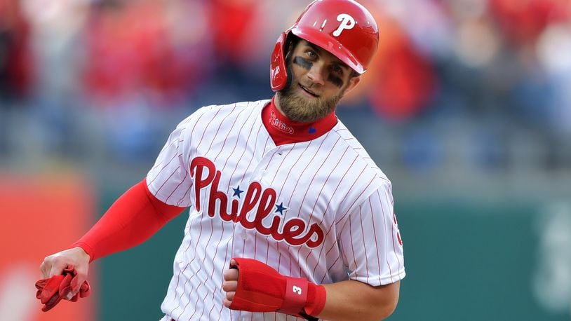 PHILADELPHIA, PA - MARCH 28: Bryce Harper #3 of the Philadelphia Phillies rounds the bases to score a run on a grand slam home run by Rhys Hoskins #17 during the game against the Atlanta Braves on Opening Day at Citizens Bank Park on March 28, 2019 in Philadelphia, Pennsylvania. (Photo by Drew Hallowell/Getty Images)