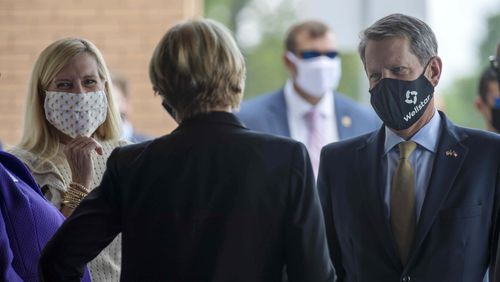 07/16/2020 - Marietta, Georgia - Wearing face masks, Gov. Brian Kemp and First Lady Marty Kemp are greeted as they arrived to the ribbon cutting ceremony for the new Wellstar Kennestone Hospital Emergency Department building in Marietta, Thursday, July 16, 2020. (ALYSSA POINTER / ALYSSA.POINTER@AJC.COM)