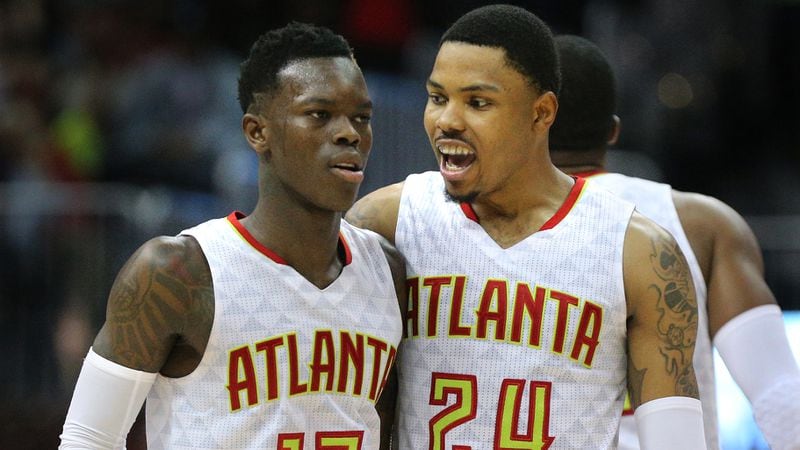 Dennis Schroder and Kent Bazemore celebrate a 111-101 victory over the Wizards in game 4 of a first-round NBA basketball playoff series on Monday, April 24, 2017, in Atlanta.  Curtis Compton/ccompton@ajc.com
