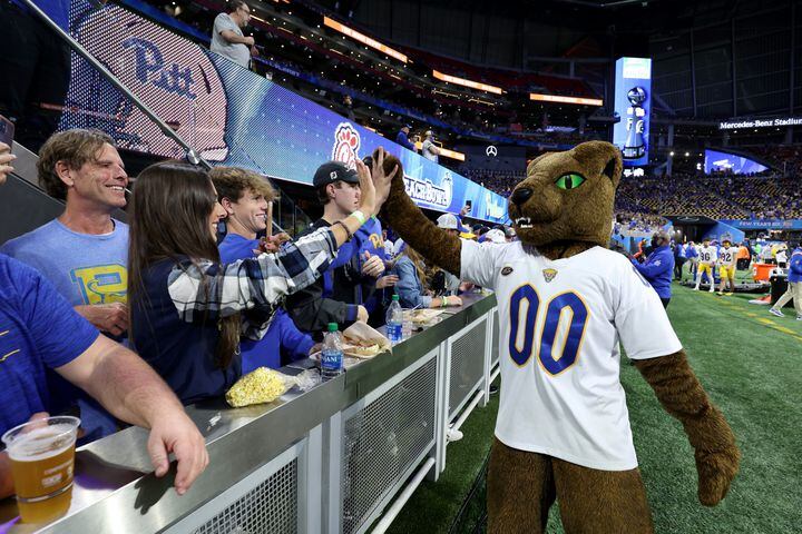 Pittsburgh Panthers mascot Roc high fives fans before the Chick-fil-A Peach Bowl between the Pittsburgh Panthers and the Michigan State Spartans at Mercedes-Benz Stadium in Atlanta, Thursday, December 30, 2021. JASON GETZ FOR THE ATLANTA JOURNAL-CONSTITUTION