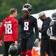 Atlanta Falcons quarterback Kirk Cousins (18) talks with tight end Kyle Pitts (8) during minicamp at the Atlanta Falcons Training Camp, Tuesday, May 14, 2024, in Flowery Branch, Ga. (Jason Getz / AJC)

