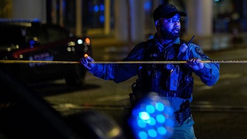 An Atlanta police officer secures the scene after a shooting at the 17th Street bridge near Atlantic Station left one person dead and several injured on Saturday night, Nov. 26, 2022. (Photo: Ben Hendren for The Atlanta Journal Constitution)