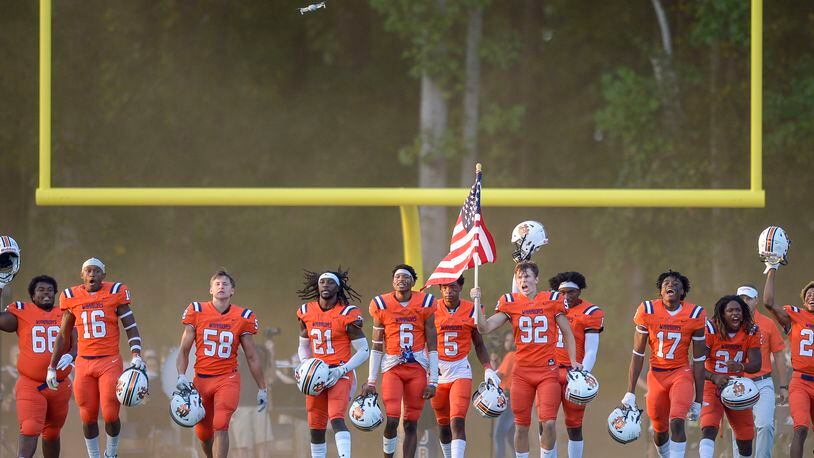 The North Cobb Warriors take the field at the start of their home game Friday, Sept. 11, 2020, against Buford in Kennesaw. (Daniel Varnado/For the AJC)