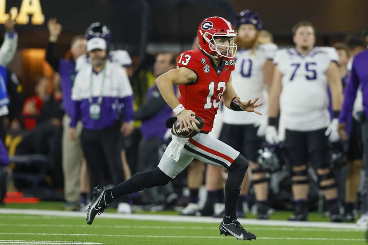 Georgia Bulldogs quarterback Stetson Bennett (13) runs against the TCU Horned Frogs during the first half of the College Football Playoff National Championship at SoFi Stadium in Los Angeles on Monday, January 9, 2023. (Jason Getz / Jason.Getz@ajc.com)