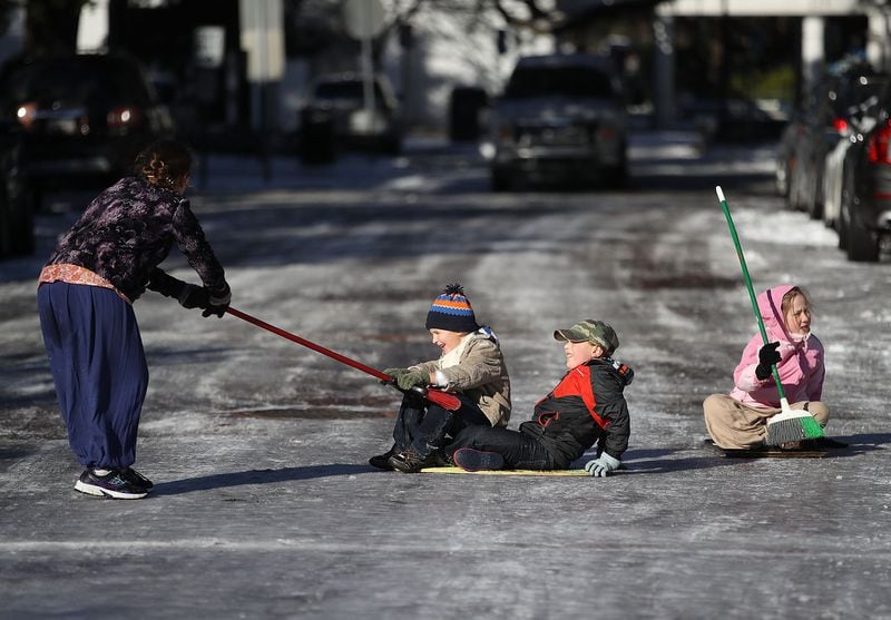 SAVANNAH, GA - JANUARY 04: (L-R) Telem Fenster, Jediah Pendergrass, Shebuel Fenster and Keren Fenster play on an icy street on January 4, 2018 in Savannah, Georgia. From Maine to Florida every state along the east coast is expected to have to deal with winter weather. (Photo by Joe Raedle/Getty Images) *** BESTPIX ***