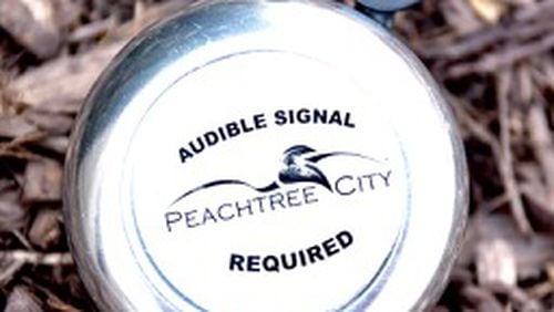 Peachtree City is giving away bells to remind golf cart drivers to use audible warnings when approaching pedestrians. Jill Howard Church for the AJC