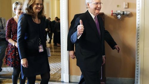 Senate Majority Leader Mitch McConnell of Kentucky gives a thumbs up Monday as he leaves the Senate floor after reaching an agreement to advance a bill ending the government shutdown that began Saturday morning. (AP Photo/Jacquelyn Martin)