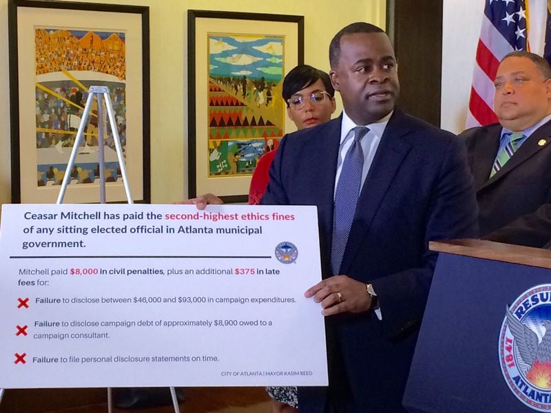 Atlanta Mayor Kasim Reed at a news conference in which posters were used to emphasize City Council president and mayoral candidate Ceasar Mitchell's ethics fines.