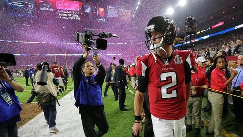 A dejected Matt Ryan walks off the field as the confetti flys falling to the Patriots 34-28 in the Super Bowl on Sunday Feb. 5, 2017, in Houston. This game is the most-watched sporting event in 2017 through July 12. Curtis Compton/ccompton@ajc.com