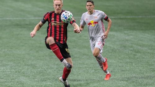Atlanta United defender Jeff Larentowicz (18) controls the ball while being defended by  New York Red Bulls midfielder Sean Davis (27) during the second half in a MLS at Mercedes-Benz Stadium on Saturday, Oct. 10, 2020, in Atlanta. Branden Camp/For the Atlanta Journal-Constitution