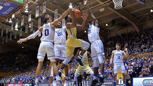 Josh Okogie of the Georgia Tech Yellow Jackets drives between Jayson Tatum (0), Marques Bolden (20) and Amile Jefferson (21) of the Duke Blue Devils during the game at Cameron Indoor Stadium on January 4, 2017 in Durham, North Carolina. Duke won 110-57. (Photo by Grant Halverson/Getty Images)
