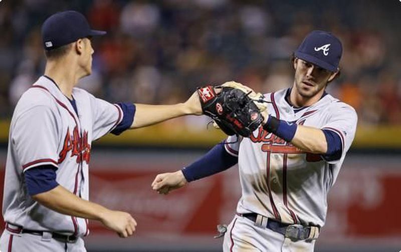 Matt Wisler (left) greets rookie shortstop Dansby Swanson after Swanson made a nice play during Wisler's dominant outing Thursday at Arizona. (AP photo)