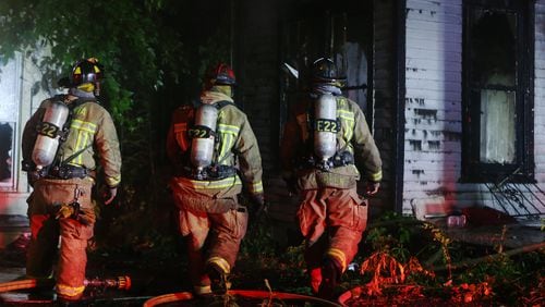 June 19, 2019 Atlanta- A firefighters from Atlanta Fire Rescue approach the scene of a two-house fire that resulted in one injury on the 600 block of James P. Brawley in Atlanta a little after 5 a.m. on Wednesday, June 19, 2019. Firefighters arrived to find a significant fire in the rear of a vacant home, according to Atlanta Fire Rescue Battalion Chief, Jason Wozniak. The fire spread quickly to an occupied adjacent home to the left of the burning vacant house. "We had to pull out of the main fire building and go defensive to put out the main body of fire," Wozniak said. Initial reports of a burn victim at the scene were unconfirmed, but a victim later admitted himself at Grady hospital said Atlanta Fire Rescue Spokesperson Sgt. Cortez Stafford. It was not known whether the victim came from the vacant or occupied structure. The fire is under investigation. CHRISTINA MATACOTTA/CHRISTINA.MATACOTTA@AJC.COM