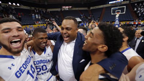Georgia State head coach Ron Hunter celebrates with his team after their victory over Texas-Arlington in the Sun Belt Conference championship game in New Orleans, Sunday, March 11, 2018.