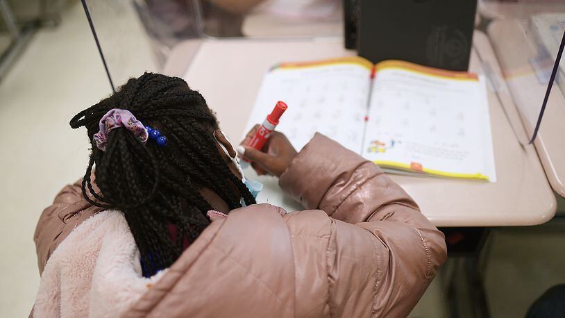 A student at Thurgood Marshall Elementary in Morrow works on a math problem during class on April 19, 2022. Students across the state took the Georgia Milestones in April and May, but the federal government says they don't need to inform school report cards this year. (Natrice Miller / natrice.miller@ajc.com)