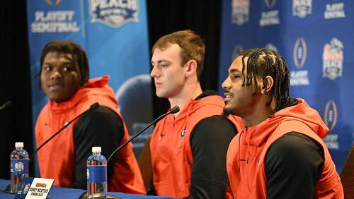 Bulldogs lineman Broderick Jones (from left), tight end Brock Bowers and running back Kenny McIntosh answer questions from members of the media during Georgia's news conference Wednesday in Atlanta. (Hyosub Shin / Hyosub.Shin@ajc.com)
