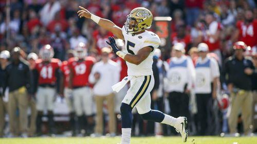 Georgia Tech quarterback Justin Thomas led the Yellow Jackets to touchdowns on their final two drives to escape a 13-point fourth-quarter deficit and win 28-27 over Georgia. (Associated Press)