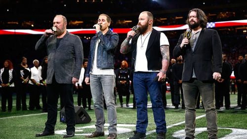 The Zac Brown Band (shown singing the national anthem at the College Football Playoff National Championship in Atlanta) will try to score another Grammy win on Sunday. Photo: Getty Images