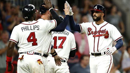 Right fielder Nick Markakis of the Atlanta Braves (right) is congratulated by teammates after hitting a 3-run home run in the sixth inning during the game against the Miami Marlins at SunTrust Park on August 4, 2017 in Atlanta, Georgia.  (Photo by Mike Zarrilli/Getty Images)