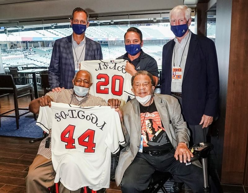 Richard Sneed, Principal Chief of the Eastern Band of Cherokee Indians, middle top, attended the Braves' home opener last year where they unveiled some specialized jerseys. Top left is Braves CEO Derek Schiller and top right is chairman Terry McGuirk. Bottom left is Hank Aaron and former Atlanta Mayor Andy Young. (Credit: The Atlanta Braves)