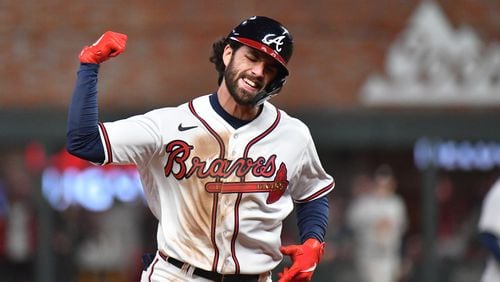 10/30/21 - Atlanta - Atlanta Braves shortstop Dansby Swanson reacts after hitting a solo home run to tie the game at two runs against the Houston Astros during the seventh inning of game 4 in the World Series at Truist Park, Saturday October 30, 2021, in Atlanta.Hyosub Shin / Hyosub.Shin@ajc.com