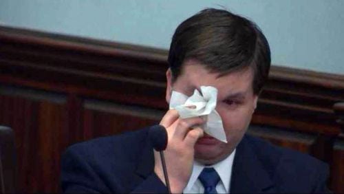 Ross Harris wipes away tears during his attorney’s opening statement Tuesday in Harris’s murder trial in Brunswick. (Screen capture from WSB-TV video)