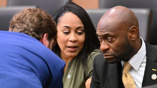 District Attorney Fani Willis, center, confers with lead prosecutors, Donald Wakeford, left, and Nathan Wade, during a motion hearing at Fulton County Courthouse in Atlanta on Friday, July 1, 2022. (Hyosub Shin/The Atlanta Journal-Constitution/TNS)